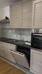 a kitchen with a sink and a microwave at Studio apartman Katja in Karlovac