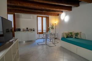 a living room with a couch and a table at Sotto la torre Apartment in Cagliari