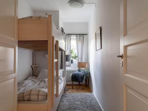 a small bedroom with a bunk bed and a hallway at 2-Story Condo with Terrace in Åre