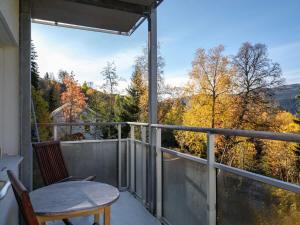 a balcony with a table and a view of the mountains at 2-Story Condo with Terrace in Åre +15 photos