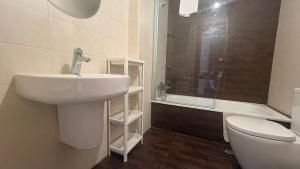 a bathroom with a sink and a toilet and a shower at Oktheway Miño in Miño