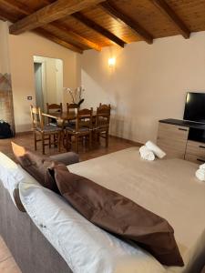 a room with a bed and a table and chairs at Mespilia - Tra Mare e Città in Latina