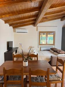 a living room with a table and a bed at Mespilia - Tra Mare e Città in Latina
