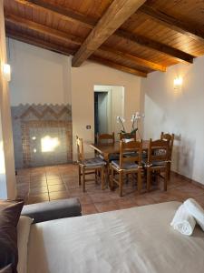 a room with a table and chairs and a fireplace at Mespilia - Tra Mare e Città in Latina