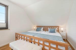 a bedroom with a large bed and a window at Ferienhaus Sonnendeck in Ueckeritz