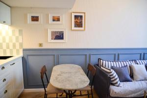 a living room with a couch and a table at The Blue Cottage in Nice +14 photos