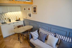 a kitchen with a couch and a table with pillows at The Blue Cottage in Nice
