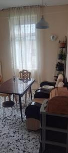 a living room with a table and chairs and a window at Guramishvili 5 in Kobuleti +13 photos