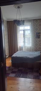a bedroom with a bed and a window at Guramishvili 5 in Kobuleti