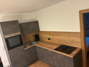 a small kitchen with a counter and a sink at FEWO-TomKO in Fügenberg +1 photo