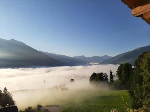 a view of a foggy valley with mountains at FEWO-TomKO in Fügenberg