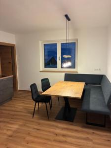 a dining room with a table and two chairs at FEWO-TomKO in Fügenberg
