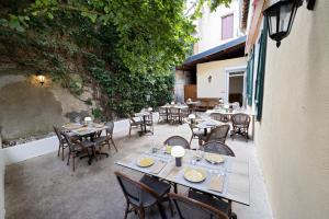 an outdoor dining area with tables and chairs at Hotel De Paris Jaligny in Jaligny