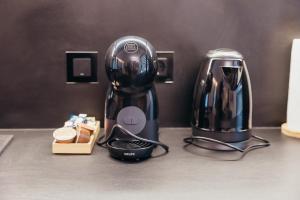a coffee maker on a counter next to a toaster at Nivalis Resort and SPA in Muntele Băişorii