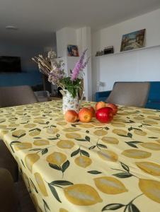 a table with a table cloth with fruit and flowers on it at Apfelblüte in Stockach +10 photos
