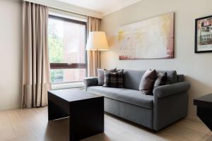 a living room with a couch and a window at Scandic Stavanger Park in Stavanger