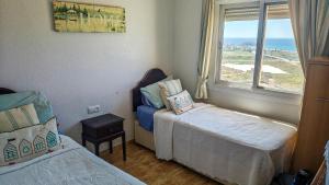 a small bedroom with two beds and a window at Casa Las Vistas in Bolnuevo +39 photos
