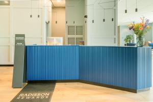 a blue counter in an office with flowers on it at Radisson Blu Hotel Amsterdam Airport, Schiphol in Schiphol