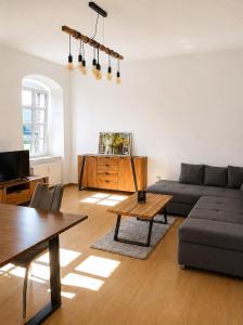 a living room with a couch and a table at Gut Rottmannshagen Mecklenburgische Seenplatte in Jürgenstorf