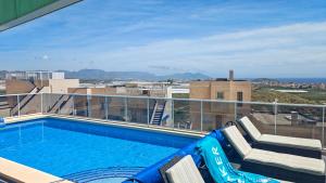 a swimming pool on the roof of a building at Casa Las Vistas in Bolnuevo