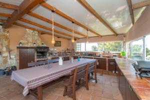 a large kitchen with a large table and chairs at House close to the beach! Pool, ocean view! in Santa Susanna