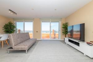 a living room with a couch and a flat screen tv at House close to the beach! Pool, ocean view! in Santa Susanna