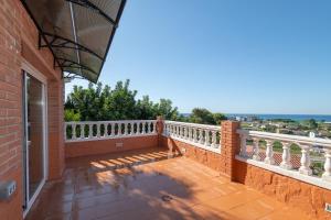 a balcony of a house with a view of the ocean at House close to the beach! Pool, ocean view! in Santa Susanna
