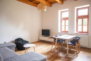 a living room with a couch and a table at Pod Skalou in Temeš