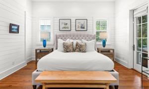 a bedroom with a large white bed with two tables at Southern Living Cottage in Santa Rosa Beach +59 photos