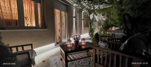 a balcony with a table with flowers on it at Apartma REA Izola, pergola & terassa, parking in Izola
