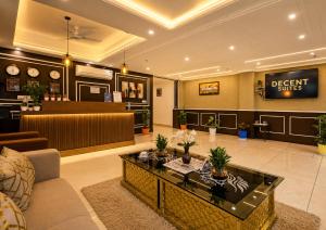 a lobby with a waiting room and a reception desk at Hotel Decent Suites - Delhi Airport in New Delhi