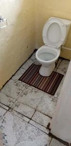 a bathroom with a toilet in a room at Beachside Haven Homestay in Yarawa Island