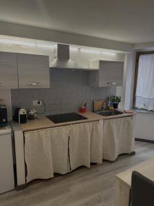 a kitchen with a table with a cloth on it at B&B Pudzones in Santu Lussurgiu +9 photos