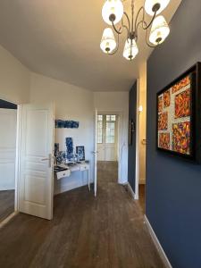a living room with a painting on the wall at Manoir du Moulin Fleury in Villedieu-les-Poêles