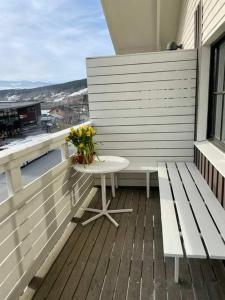 a balcony with a table and flowers on a building at Central Apartment with Sauna & Balcony in Åre