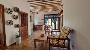 a living room with a table and a chair at Bantu Home in Paje +50 photos