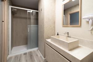 a bathroom with a sink and a shower at Apartamentos El Real in Mota del Cuervo +34 photos