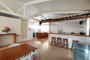 a kitchen with a table and chairs and a counter at Shenna's Beach Resort Boracay in Boracay