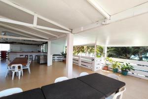 a living room with a black table and white chairs at Shenna's Beach Resort Boracay in Boracay