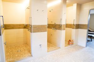 a bathroom with a shower with glass doors at ROD32d "Carpe Diem" Schmidt in Niendorf +5 photos