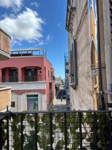 a view from a balcony of a pink building at DimoraStella in Pezze di Greco