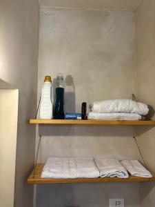 a shelf with towels and other items on it at DimoraStella in Pezze di Greco
