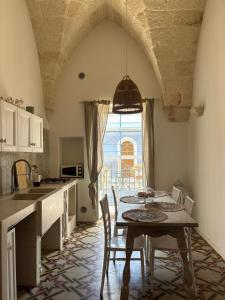 a kitchen with a table and chairs in a room at DimoraStella in Pezze di Greco