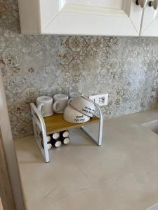 a shelf with pots and mugs on it in a kitchen at DimoraStella in Pezze di Greco