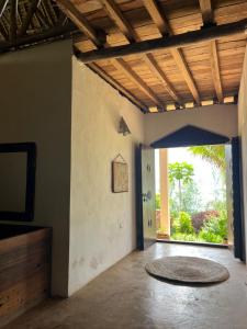 a room with a hallway with a door and a rug at Sazani Beach Lodge and Tidal Lounge in Nungwi
