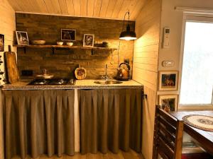 a kitchen with a sink and a stove at Little Bali in Geel