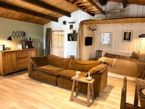 a living room with a couch and a bed at Little Bali in Geel