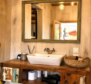 a bathroom with a sink and a mirror at Little Bali in Geel +11 photos