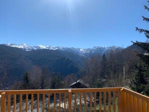 a wooden balcony with a view of mountains at Chalet chaleureux à Ax-les-Thermes avec vue sur la montagne in Ax-les-Thermes +11 photos
