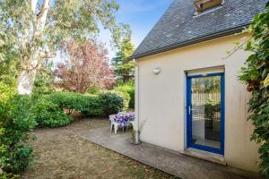 a house with a blue door and a table at Appartement confortable avec terrasse à Arzon - 60 m² in Arzon